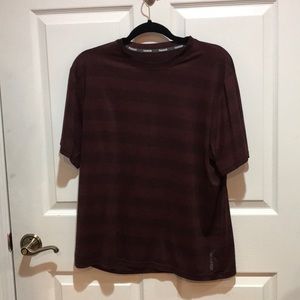 A striped red breathable Reebok shirt.